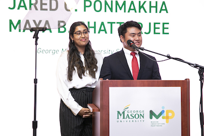 two students at podium