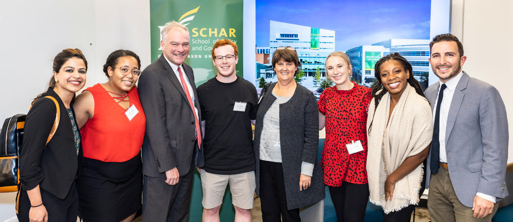 U.S. Senator Tim Kaine and his wife, Schar School professor Anne Holton, pose with students at the Master's in Public Policy Bistro event.
