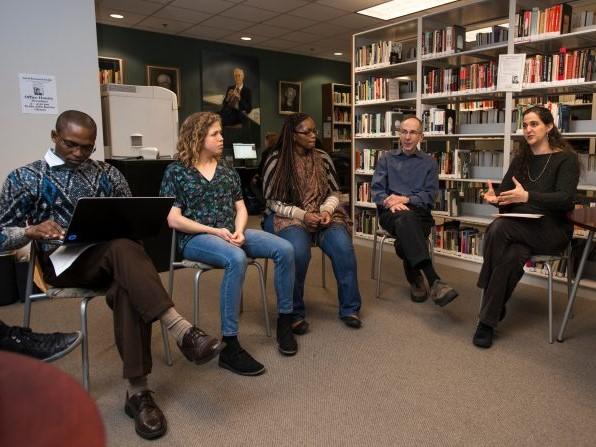 A discussion group works in the Burton Library.